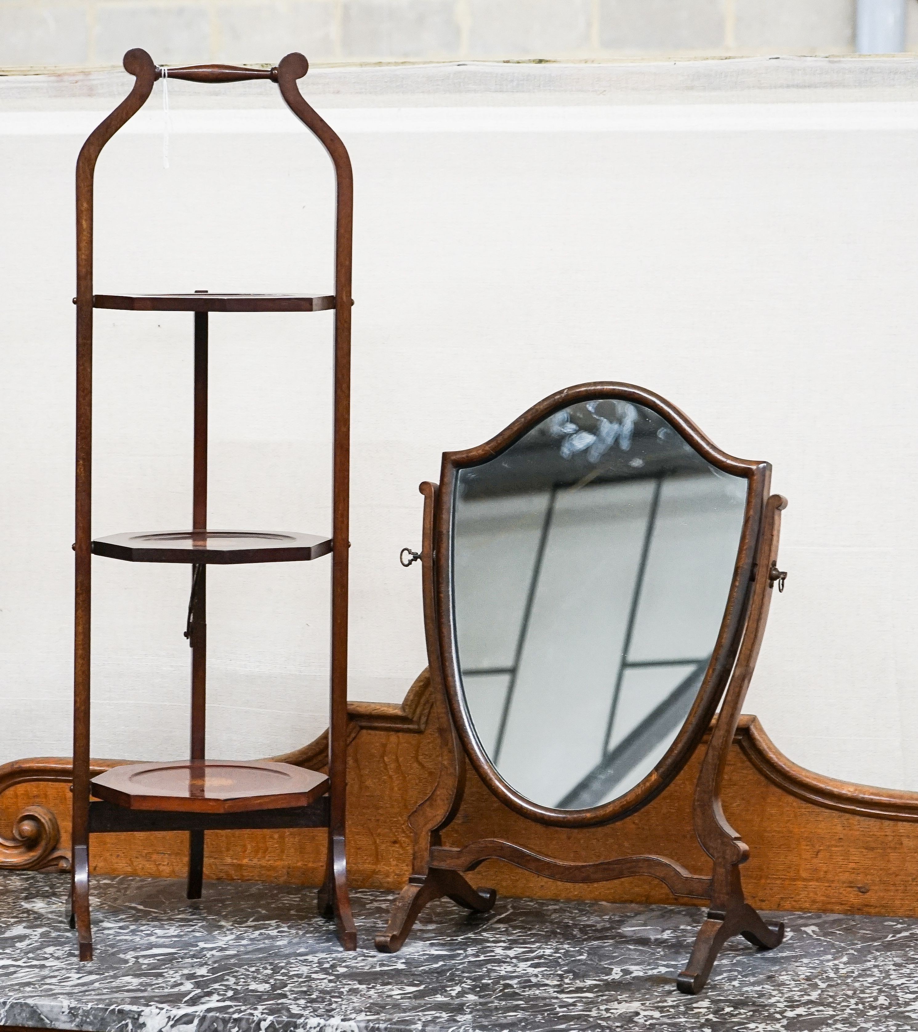 An Edwardian cake stand together with a skeleton framed toilet mirror